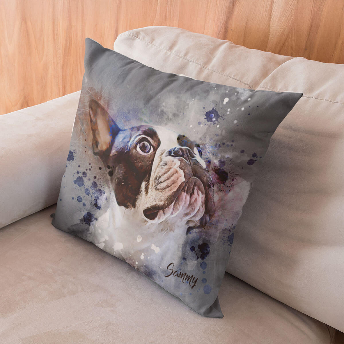 Decorative pillow with a dog illustration on a beige couch.